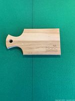 Top view of entire cutting board showing logo and handle