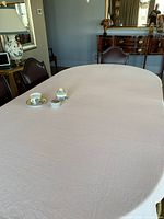 Table view showing full light pink tablecloth on dining table