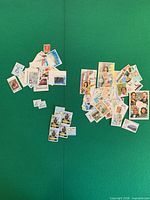 Two piles of assorted Latin American stamps on green background
