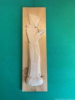 Front view of full relief carving showing subject and plaque