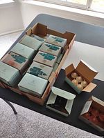 Cardboard tray holding multiple Partylite six-pack candle boxes