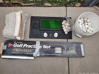 Overall lot showing folded net, hitting mat, bucket of balls, boxed practice net and tees