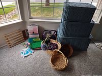 Overall lot showing blue baskets, natural baskets and craft supplies