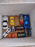 box of assorted sports cars and trucks