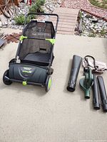 Earthwise Sweepit assembled beside blower/vac components on patio