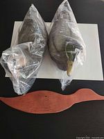Two bagged plastic duck decoys and wood silhouette overview
