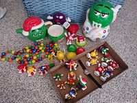overview of all M&M items including cookie jar, mugs, beads, figures and watch