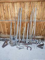 group shot of sticks, tools, brackets, log, horseshoe