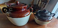 Both bean crocks side by side showing size difference and lids