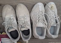 Top view of both pairs side by side showing uppers, laces, size tag on one shoe