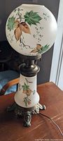 Full view of hurricane lamp showing both globes, painting, base, wiring