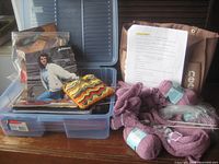 Overview of patterns, tote bag, unfinished project and yarn