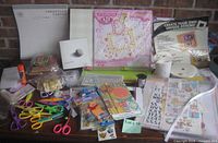Full view of cardstock pad, album kit, idea book, scissors, stickers, embellishments