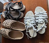 Top view of three footwear pairs on table