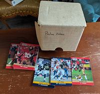 Closed box labelled "Proline Extras" with four sample NFL Proline cards including Jerry Rice and Ronnie Lott displayed