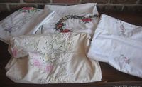 All four folded embroidered tablecloths