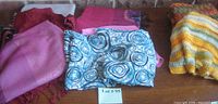 Group of folded scarves on table