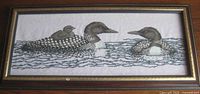 full view of framed needlepoint showing subject and frame