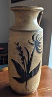 Front view of beige speckled Scheurich vase with black floral design