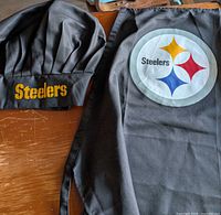 Apron and chef hat laid out, showing Steelers logo and embroidery