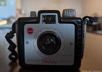 Front view showing lens, faceplate, Kodak logo, wrist strap