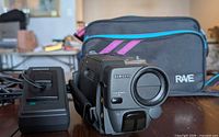 Front view of Samsung camcorder with charger and carrying bag