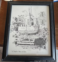 Full view of framed sailboat sketch print in black frame