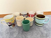 Group of nine assorted mugs front and back