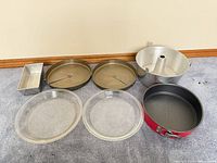 All seven bakeware pieces displayed on carpet
