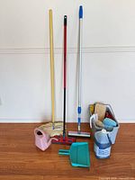 Overview of mops, squeegee, dustpan, watering can, caddy and chemical jug