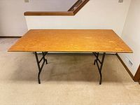 Full view of table standing with legs extended