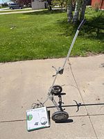 Play Day foldable golf push cart and boxed chipping net on driveway