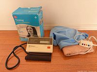 Overall lot showing blood pressure monitor, heating pad and Therabag box