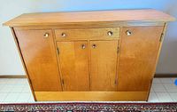 Front view of closed cabinet showing four doors and one drawer