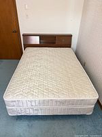 Full bed setup showing mattress, box spring, headboard