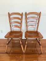 Front view of two honey oak solid wood ladderback chairs