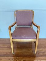 Front view of armchair showing upholstery and wood frame