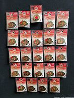 Front view of all 24 retail-carded pins laid out