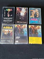 Front view of six ABBA cassette tapes showing album artwork