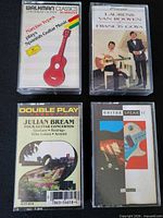 Front view of four audio cassette tapes in cases