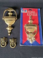 Front view of all four brass door knockers