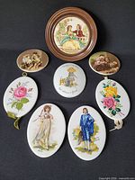 Group shot of all eight ceramic plaques