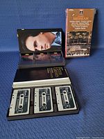All three boxed sets, two opened showing cassettes, one sealed