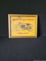 Front view of framed Harley-Davidson advertising print