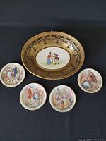 Front view of brass basket with porcelain insert and five saucers