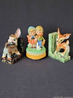 Group shot of donkey bookend, music box figurine, and fawn bookend