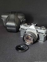 Camera with lens, lens cap, and case