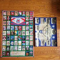Both posters laid flat on hardwood floor, shows relative sizes and overall designs