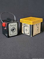 Front view of Imperial Six-Twenty camera beside original box