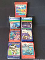 Front view of all seven boxed Intellivision games